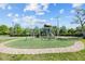 Outdoor playground featuring a climbing structure on a cushioned surface surrounded by a brick walkway at 5482 Salem Square N Dr, Palm Harbor, FL 34685