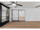 Enclosed sunroom with carpet, ceiling fan, and access to yard via sliding glass doors at 5482 Salem Square N Dr, Palm Harbor, FL 34685