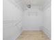 Walk-in closet features new flooring and ample storage space at 5482 Salem Square N Dr, Palm Harbor, FL 34685
