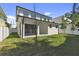 Expansive backyard featuring well-maintained lawn and a view of the home's rear exterior at 6315 S Richard Ave, Tampa, FL 33616