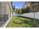 Nicely manicured backyard with verdant lawn, enclosed by a white fence at 6315 S Richard Ave, Tampa, FL 33616