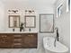 Bright bathroom featuring a double sink vanity, soaking tub, and modern fixtures, creating a spa-like experience at 6315 S Richard Ave, Tampa, FL 33616