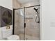 Contemporary bathroom with tiled walk-in shower, black hardware, and updated fixtures, offering a modern and functional design at 6315 S Richard Ave, Tampa, FL 33616
