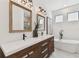 Modern bathroom featuring double vanity, soaking tub, marble floors, and sleek fixtures at 6315 S Richard Ave, Tampa, FL 33616
