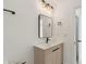 Stylish bathroom featuring a modern vanity with black fixtures and a sleek, frameless mirror at 6315 S Richard Ave, Tampa, FL 33616