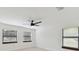 Bright bedroom with hardwood floors and ceiling fan with three well-lit windows at 6315 S Richard Ave, Tampa, FL 33616