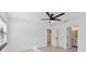 Spacious bedroom with modern ceiling fan, and views into an attached bathroom at 6315 S Richard Ave, Tampa, FL 33616