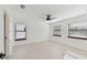 Bright bedroom with hardwood floors, ceiling fan, and natural light from the windows at 6315 S Richard Ave, Tampa, FL 33616