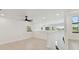 A brightly lit bonus room features hardwood floors, a ceiling fan, and several windows at 6315 S Richard Ave, Tampa, FL 33616