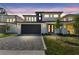 Modern two-story home boasts a dark garage door and a beautifully paved driveway at 6315 S Richard Ave, Tampa, FL 33616