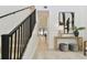 Foyer with open staircase, black banister and contemporary console table with decor at 6315 S Richard Ave, Tampa, FL 33616