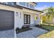 Charming front porch with black framed entry door, custom planters and a brick paved walkway at 6315 S Richard Ave, Tampa, FL 33616