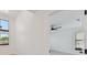 A hallway leads to a bonus room featuring a ceiling fan and natural light at 6315 S Richard Ave, Tampa, FL 33616