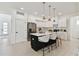 Stylish kitchen featuring a black island, white cabinets, stainless steel appliances, and pendant lighting at 6315 S Richard Ave, Tampa, FL 33616