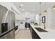 Well-lit kitchen showcasing an island with seating, stainless appliances, and a view to the living area at 6315 S Richard Ave, Tampa, FL 33616