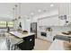 Bright kitchen featuring a black island, white cabinets, and stainless steel appliances at 6315 S Richard Ave, Tampa, FL 33616