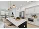 Modern kitchen featuring white cabinets, quartz countertops, an island, and stainless steel appliances at 6315 S Richard Ave, Tampa, FL 33616