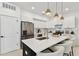 Modern kitchen showcasing white cabinets, quartz countertops, an island, and stainless steel appliances at 6315 S Richard Ave, Tampa, FL 33616