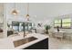 Open floor plan featuring a living room and dining room, with backyard access through sliding glass doors at 6315 S Richard Ave, Tampa, FL 33616