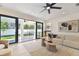Bright living room with sliding doors to patio, stylish decor, and abundant natural light, perfect for relaxation at 6315 S Richard Ave, Tampa, FL 33616
