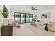 Inviting living room boasts neutral tones, modern décor, and sliding glass doors to the backyard at 6315 S Richard Ave, Tampa, FL 33616