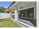 Covered patio with a ceiling fan, offering a comfortable outdoor living space and backyard access at 6315 S Richard Ave, Tampa, FL 33616