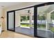 View through sliding glass doors to covered patio and backyard at 6315 S Richard Ave, Tampa, FL 33616