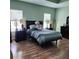 Bedroom features wood-look flooring and an inviting bed with an accent pillow, creating a cozy space at 6690 54Th N Ave, St Petersburg, FL 33709