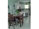 Eat-in kitchen with stainless steel appliances, white cabinets, and a cozy dining area at 6690 54Th N Ave, St Petersburg, FL 33709