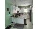 Bright kitchen features white cabinetry, a modern island, and stainless steel appliances at 6690 54Th N Ave, St Petersburg, FL 33709