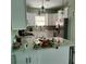 Well-lit kitchen featuring a breakfast bar, white countertops, and stainless steel appliances at 6690 54Th N Ave, St Petersburg, FL 33709