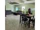 Open-concept living room and dining area, featuring tile floors and modern furniture at 6690 54Th N Ave, St Petersburg, FL 33709