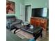 Inviting living room featuring a stylish leather chair, modern décor, and a large-screen TV at 6690 54Th N Ave, St Petersburg, FL 33709