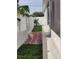 Side yard with a brick walkway, providing a charming path alongside the property's exterior at 6690 54Th N Ave, St Petersburg, FL 33709