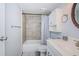 Updated bathroom features a shower-tub combo with tiled walls and white vanity sink at 801 Russell Ln # 255, Brandon, FL 33510