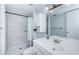 Bright bathroom with white vanity, large mirror, and tiled shower at 801 Russell Ln # 255, Brandon, FL 33510