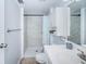 Updated bathroom featuring a tiled shower, white vanity and plenty of light at 801 Russell Ln # 255, Brandon, FL 33510