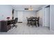 A view of a well-lit dining area featuring a table with four chairs, tile floors, a work desk and closets at 801 Russell Ln # 255, Brandon, FL 33510