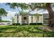 Multi-Gathering building with a large tree shading the front yard and entryway at 801 Russell Ln # 255, Brandon, FL 33510
