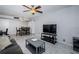 A well-lit living room featuring tile floors, a ceiling fan, and a cozy sitting area with modern gray furnishings at 801 Russell Ln # 255, Brandon, FL 33510
