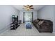 Living room features tile flooring, ceiling fan and access to a screened balcony at 801 Russell Ln # 255, Brandon, FL 33510