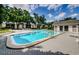 Wide shot of Community pool surrounded by lounge chairs and mature trees at 801 Russell Ln # 255, Brandon, FL 33510