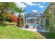 Beautiful backyard showcasing a pool inside screen enclosure with lush landscaping at 8902 30Th E St, Parrish, FL 34219