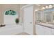 Luxurious bathroom featuring a soaking tub, separate shower, and dual vanities at 8902 30Th E St, Parrish, FL 34219