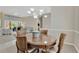 Bright dining area with a round table, adjacent to the living room and offering views of the pool at 8902 30Th E St, Parrish, FL 34219