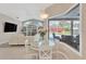 Bright dining area with a round table, open floor plan, and views of the pool at 8902 30Th E St, Parrish, FL 34219