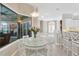 Bright dining area features a glass table, with white chairs, and a view of the pool through a large window at 8902 30Th E St, Parrish, FL 34219