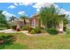 Attractive home featuring a well-kept lawn, mature landscaping, and a charming American flag display at 8902 30Th E St, Parrish, FL 34219