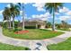 Charming single-story home boasts lush lawn and mature palms, enhancing its curb appeal on a sunny day at 8902 30Th E St, Parrish, FL 34219