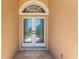 Close-up of the front doors, with decorative glass inserts and a stone-tiled entry at 8902 30Th E St, Parrish, FL 34219